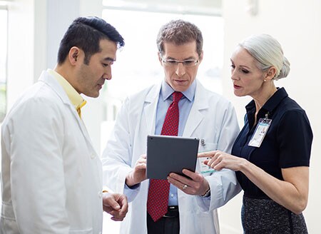 staff standing with tablet