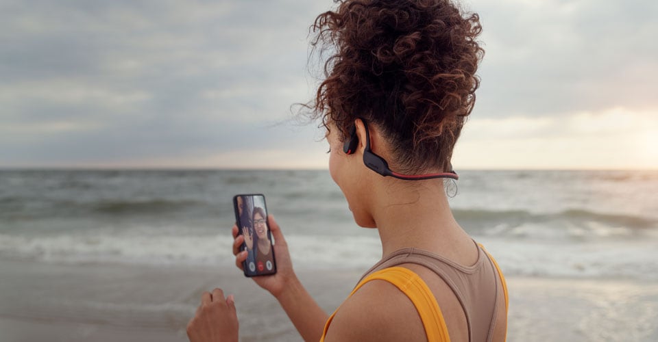 A man running outside with bone conduction headphones