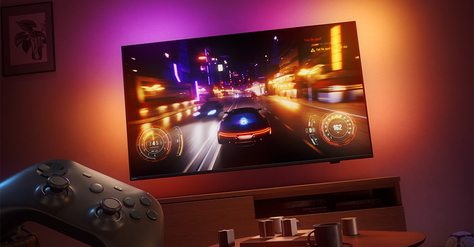 Un jeu vidéo de course est affiché sur un téléviseur Philips Ambilight dans une pièce faiblement éclairée